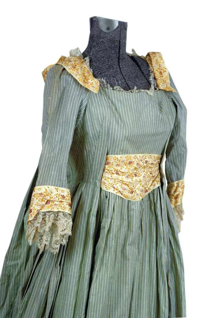 Partial view of an unknown MGM costume, cotton green & white striped gingham full-length dress