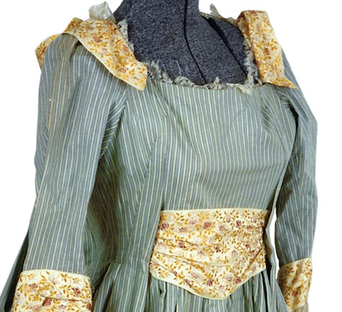 Fall_2025_Dress_Image_Featured Close up image of an unknown MGM costume, cotton green & white striped gingham full-length dress