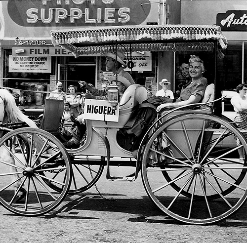 Higuera family members riding in a horse-drawn buggy.
