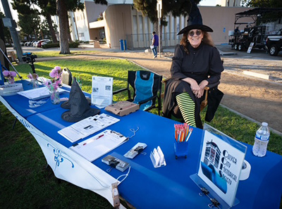 Hope at the CCHS table in costume for movies in the park