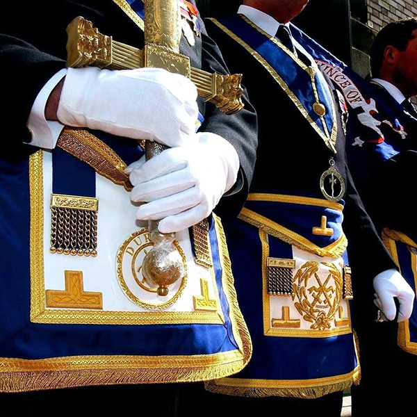 Detail image of the dress uniforms and sword of a masonic ceremony