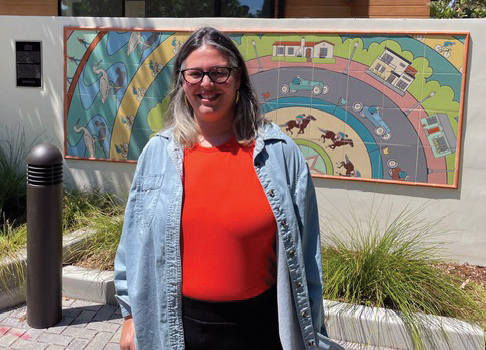 Artist Sonia Romero in front of the Farragut Connector Public Mural The Speedway