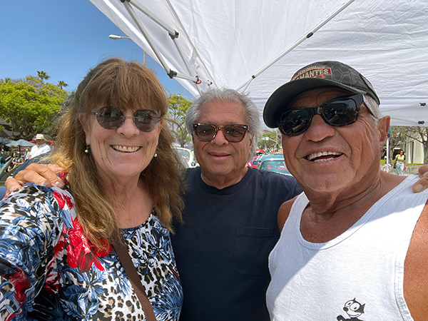 Hope, Jerry and Gil Talamantes snap a selfie among the show’s custom cars.