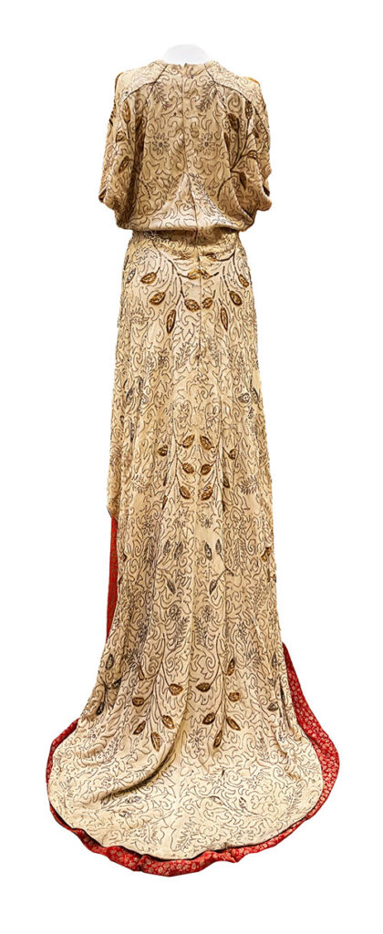 Unknown MGM dress costumer in gold and red, back view