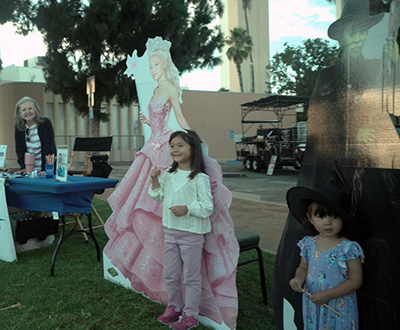 kids in front of Wicked character cut outs